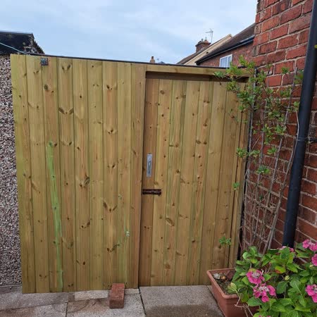 Timber side gate fitted beside the house